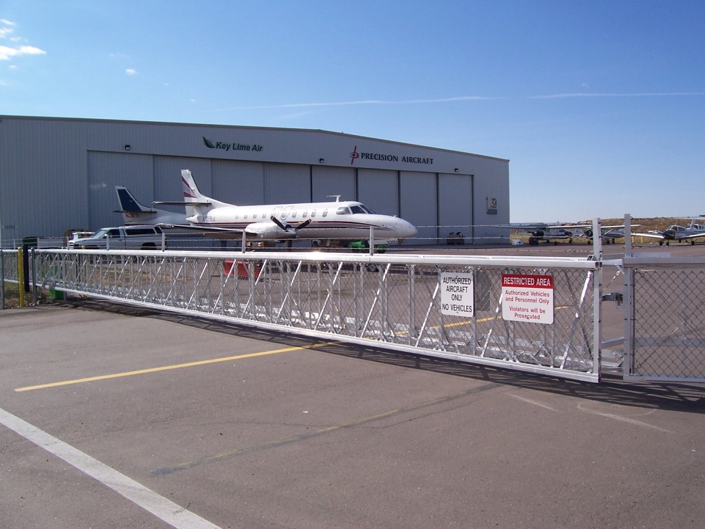 Image of a cantilever gate at an airport. The gate uses an automatic electric opener.