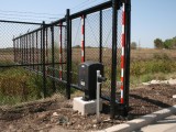Black Chain-Link Fortress Structural Cantilever security gate surrounding a warehouse