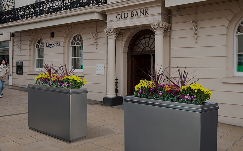 Crash barrier planters in front of bank