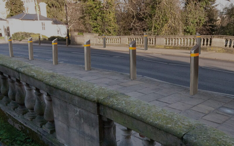 Crash bollards in a row on side of road