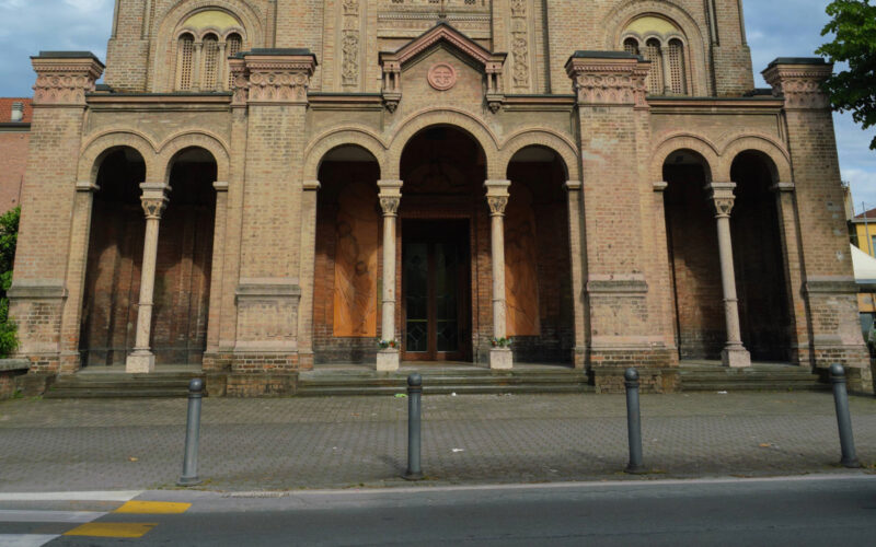 Crash-rated bollards stand outside a house of worship as a security measure.