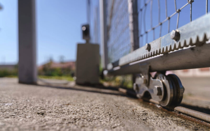 A commercial sliding gate wheel shows signs of aging